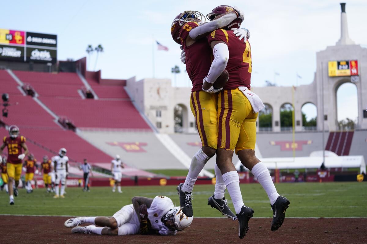 USC's Bru McCoy (4) celebrates with fellow receiver Amon-Ra St. Brown after McCoy caught a fourth-quarter touchdown pass.