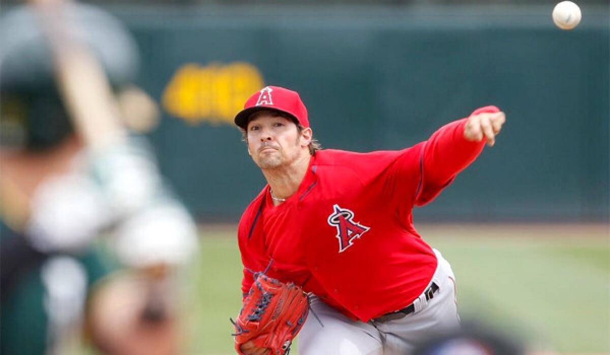 Angels left-hander C.J. Wilson pitches during a game against the Oakland Athletics on Wednesday at Phoenix Municipal Stadium.