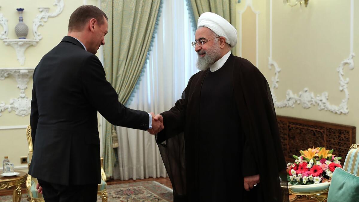 Iran's President Hassan Rouhani, right, welcomes French diplomat Emmanuel Bonne in Tehran in an image provided by the Iranian government on July 10. European nations have been working with Iran on a trade agreement.