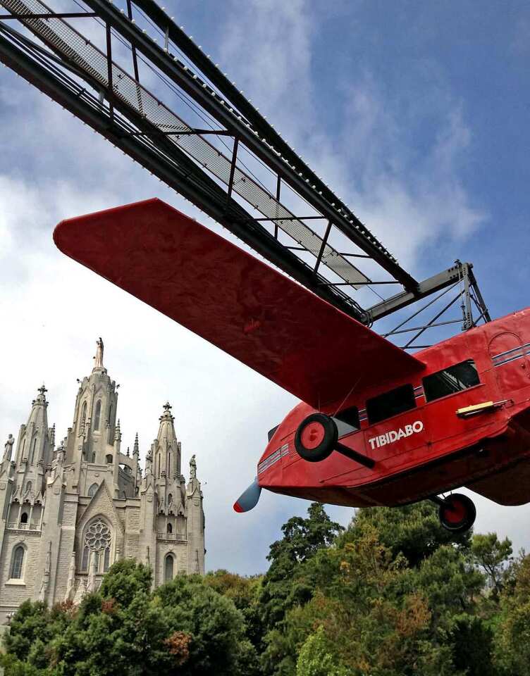 Among Barcelona's many jewels is the retro Tibidabo amusement park, where visitors can take a "ride" in a vintage plane. The Church of the Sacred Heart in the distance is perhaps a comfort to nervous fliers.