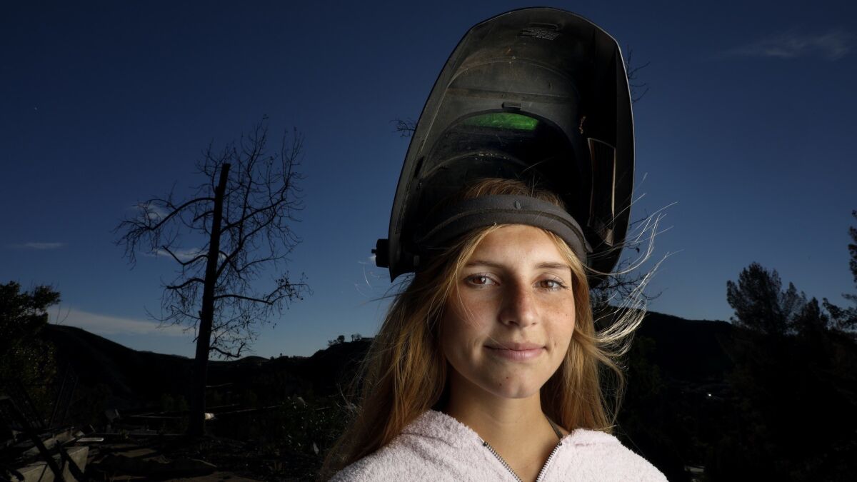 Jessica Bierschenk, 17, at the ruins of her grandmothers burned home in Bell Canyon.