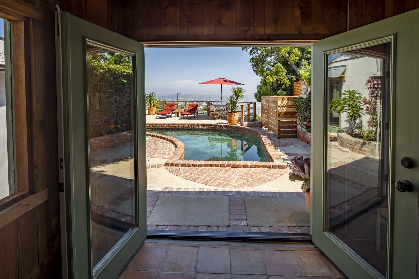 French doors in the pool house open directly to the pool deck.
