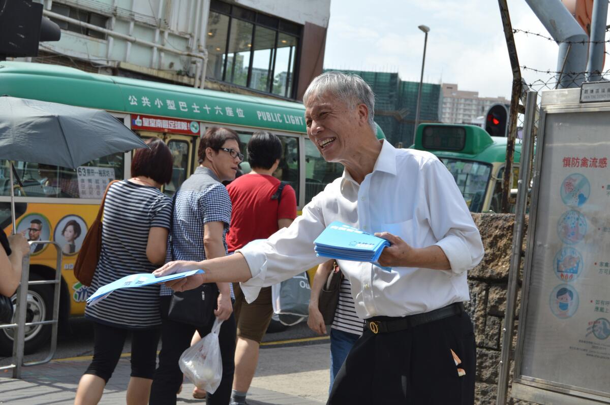 The Rev. Chu Yiu-ming hands out fliers in Hong Kong for a group called Occupy Central with Peace and Love.
