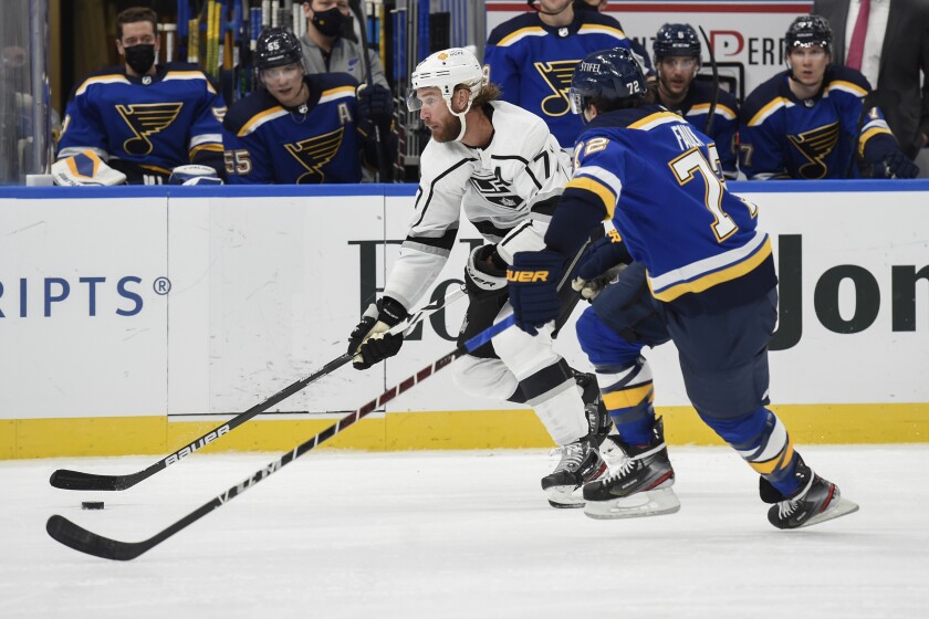 Kings forward Jeff Carter, left, controls the puck in front of St. Louis Blues defenseman Justin Faulk.