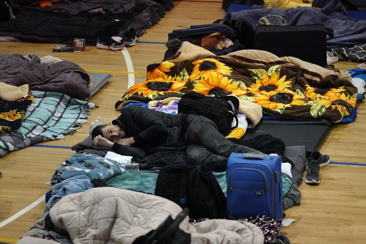 Ukrainian refugees lying on mats