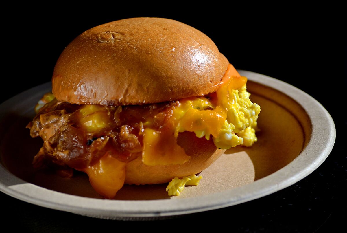 Egg Slut, the egg sandwich food truck and shop at Grand Central Market, will open a location at the Cosmopolitan Hotel in Las Vegas next year. Pictured is the Egg Slut Fairfax sandwich, made with scrambled eggs with chives, cheddar cheese, caramelized onions and Sriracha mayo on a brioche bun.