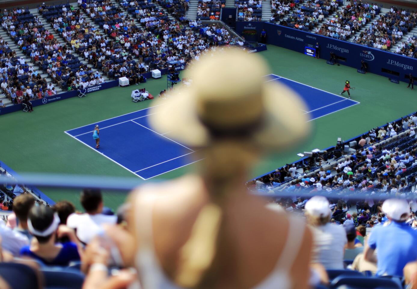 Spectators watch play between Serena Williams, right, and Kiki Bertens, of the Netherlands, during the second round of the U.S. Open tennis tournament, Wednesday, Sept. 2, 2015, in New York. (AP Photo/Matt Rourke)
