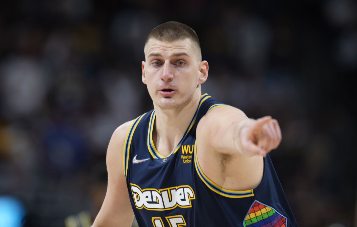 Denver Nuggets center Nikola Jokic gestures after hitting a 3-point basket against the Golden State Warriors in the first half of Game 4 of an NBA basketball first-round Western Conference playoff series Sunday, April 24, 2022, in Denver. (AP Photo/David Zalubowski)