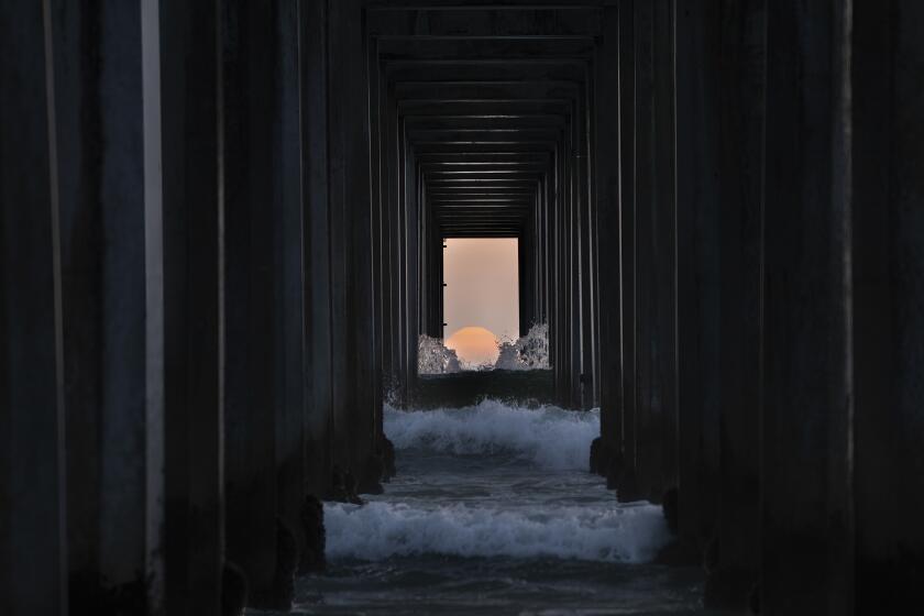 San Diego, CA - May 01: Twice a Year, the sunset in San Diego aligns perfectly with Scripps Pier in San Diego, California and dozens of folks arrive to watch and photograph the event. (Nelvin C. Cepeda / The San Diego Union-Tribune)