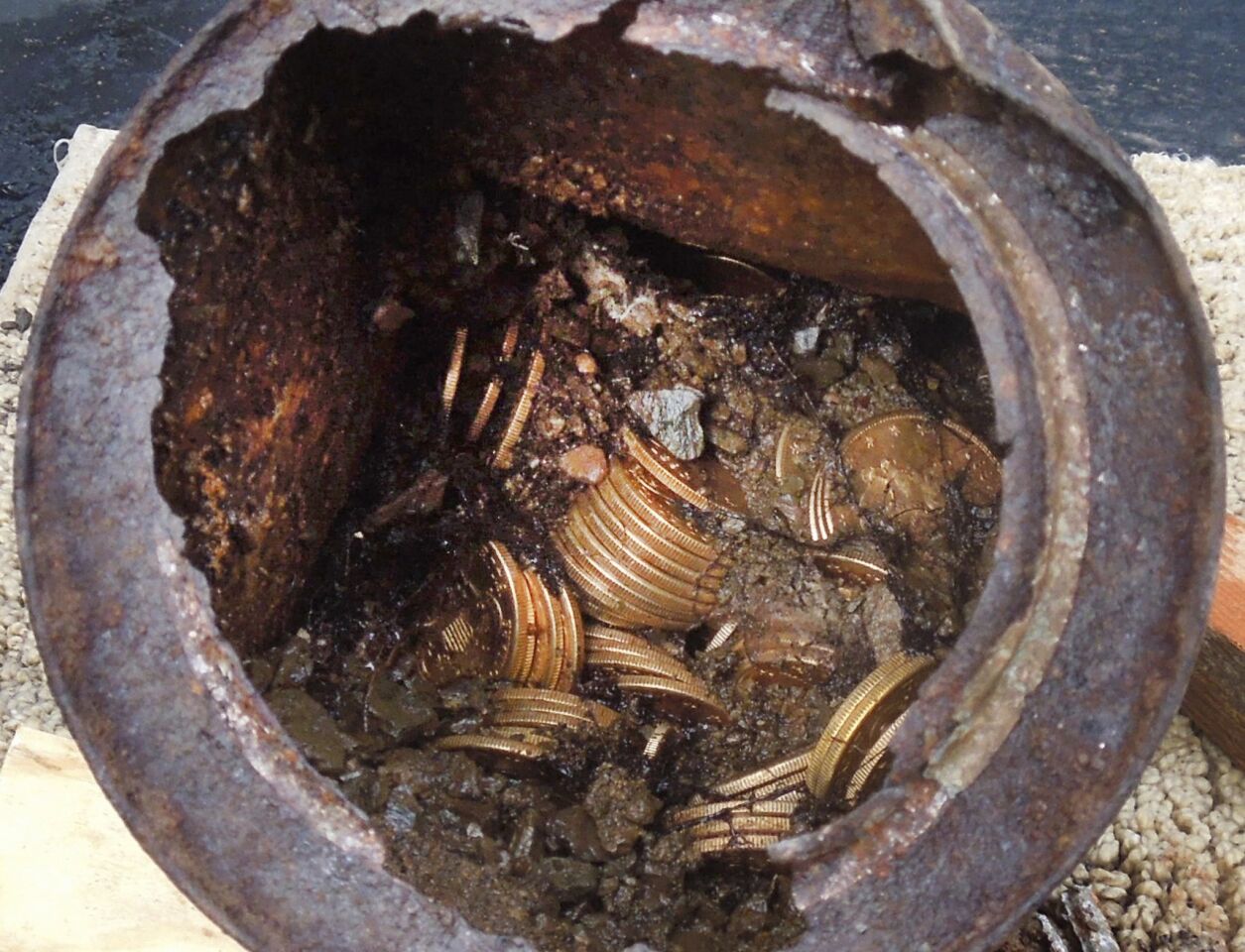 One of the six decaying metal canisters filled with 1800s-era U.S. gold coins unearthed by a couple on their property in California's gold country.