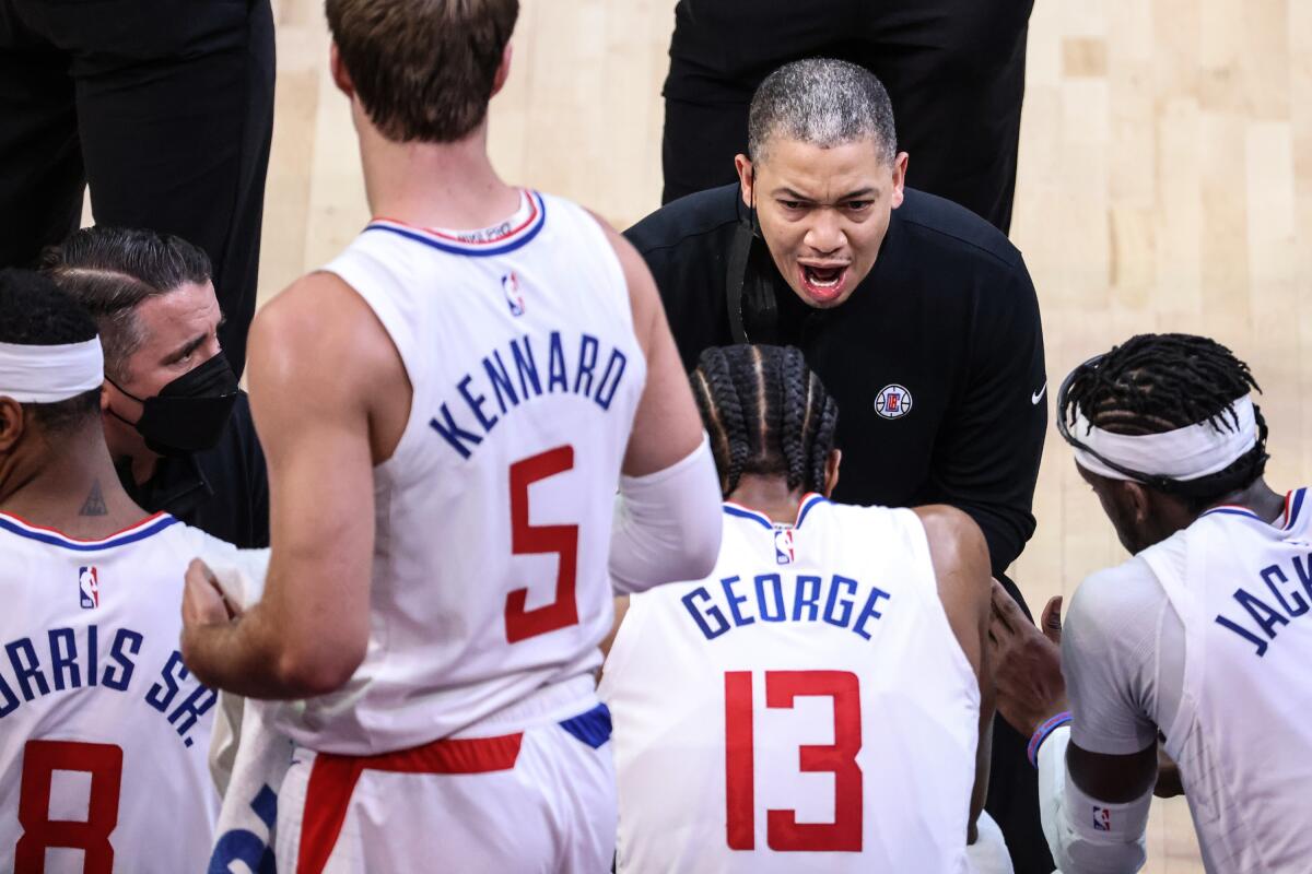 Clippers head coach Tyronn Lue leads an animated huddle during a timeout in Game 2.