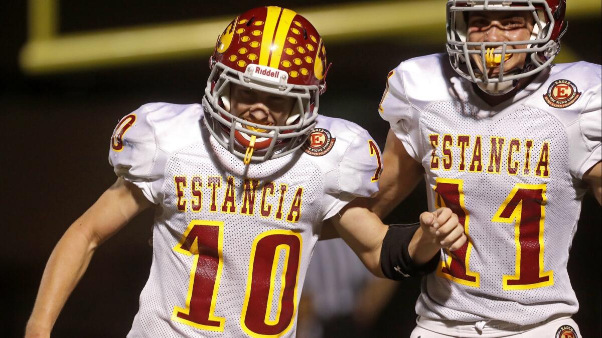 Estancia High senior running back Trevor Pacheco (10), shown celebrating a touchdown with teammate Hayden Pearce on Sept. 27 against Calvary Chapel, needs just 23 rushing yards Friday night to hit the 1,000-yard mark for the second straight year.