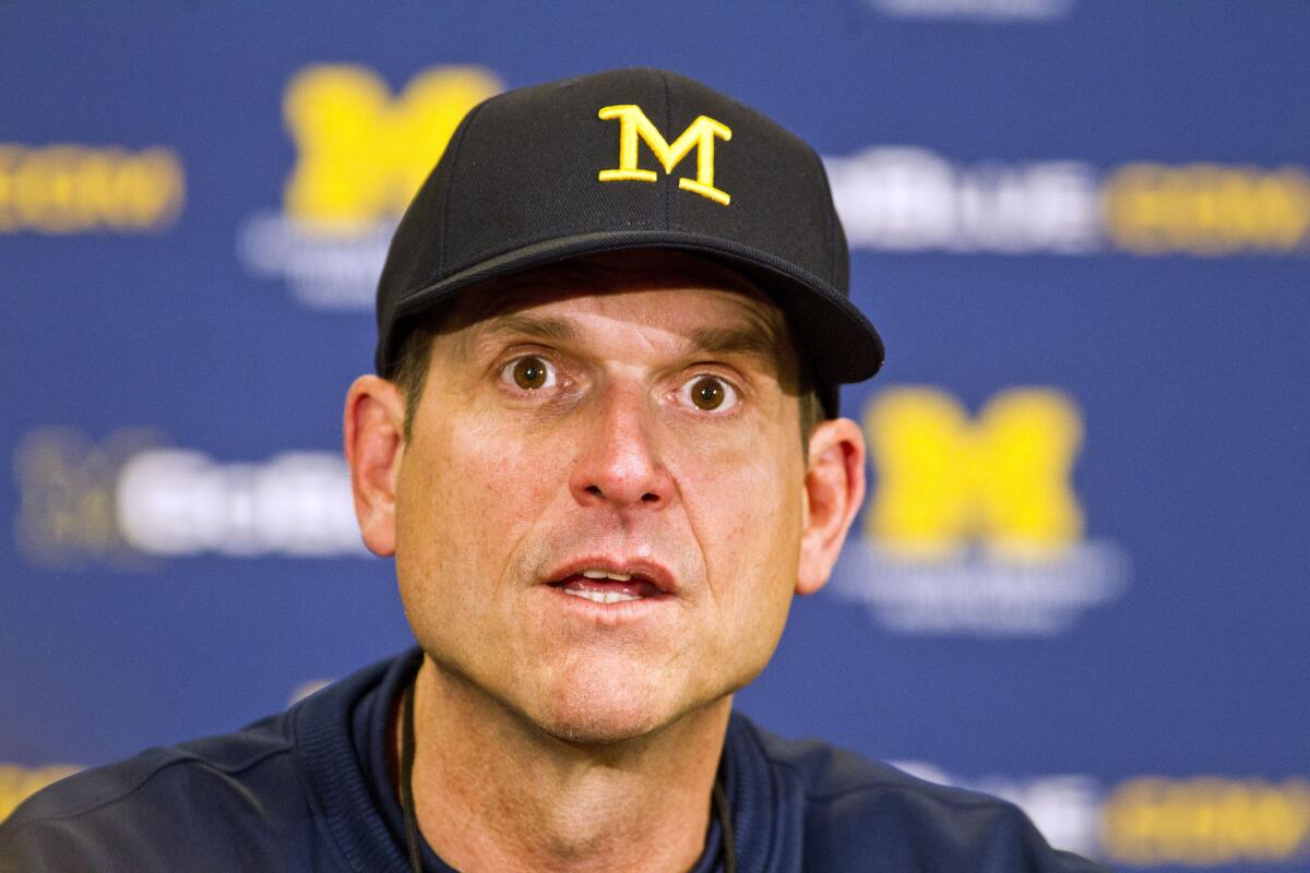 Michigan Coach Jim Harbaugh answers questions during a news conference April 4 in Ann Arbor.
