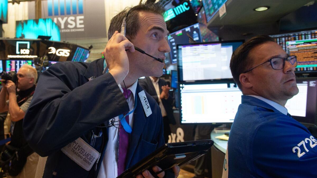 The Nasdaq composite index rose 55.93 points, or 0.7%, to a record-high 7,781.51 on Wednesday. Above, traders work on the floor of the New York Stock Exchange.