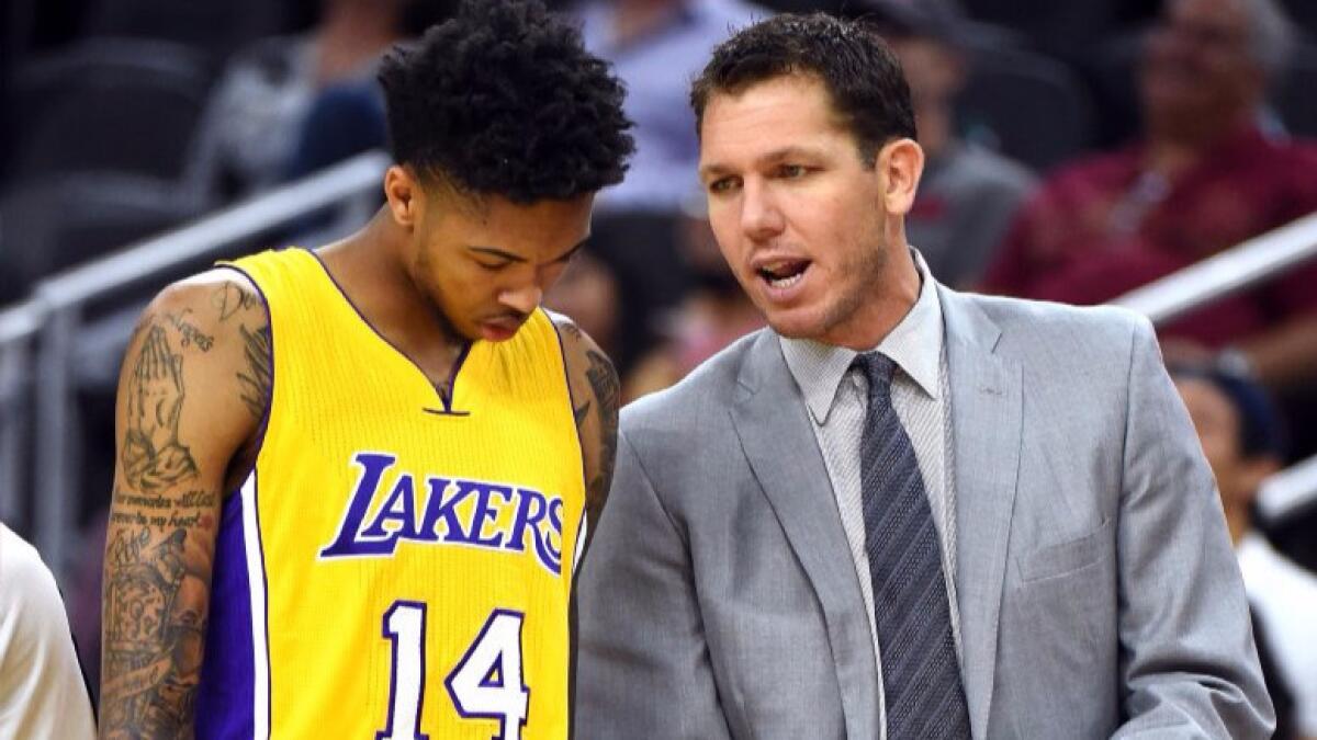 Lakers forward Brandon Ingram (14) talks to Coach Luke Walton during their preseason game against the Sacramento Kings in Las Vegas on Oct. 13.