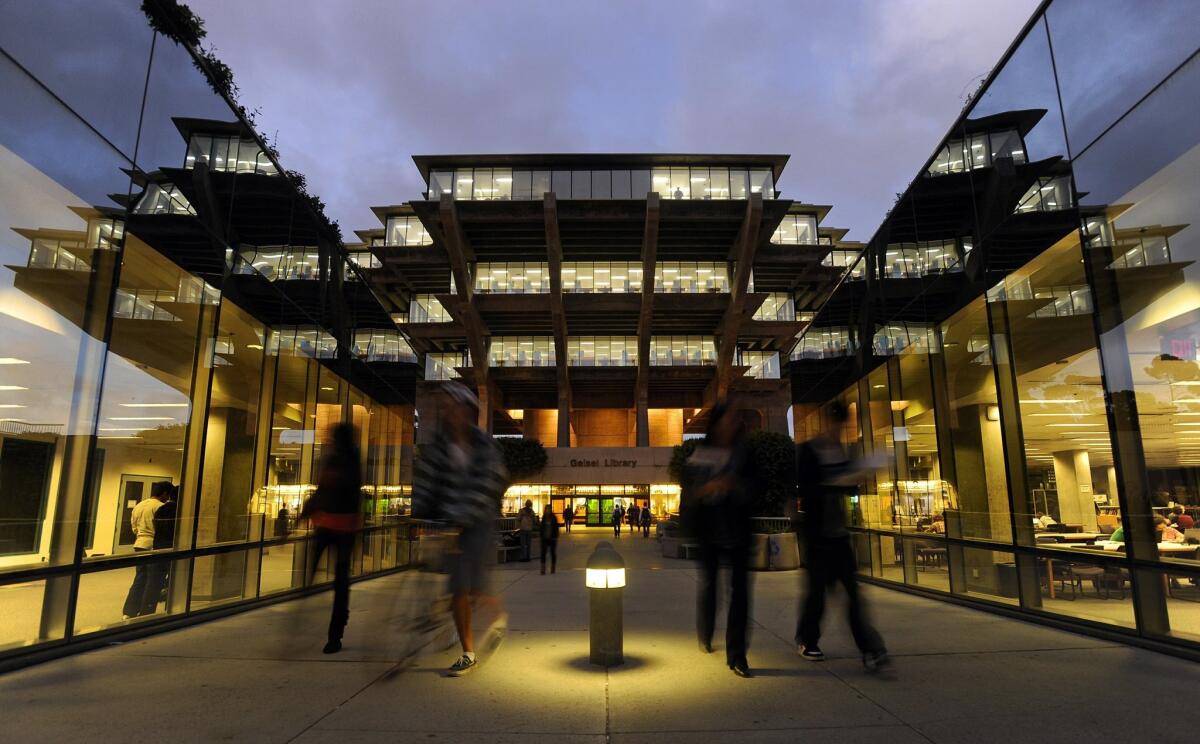 Students walk out of the Geisel Library at the University of California San Diego.