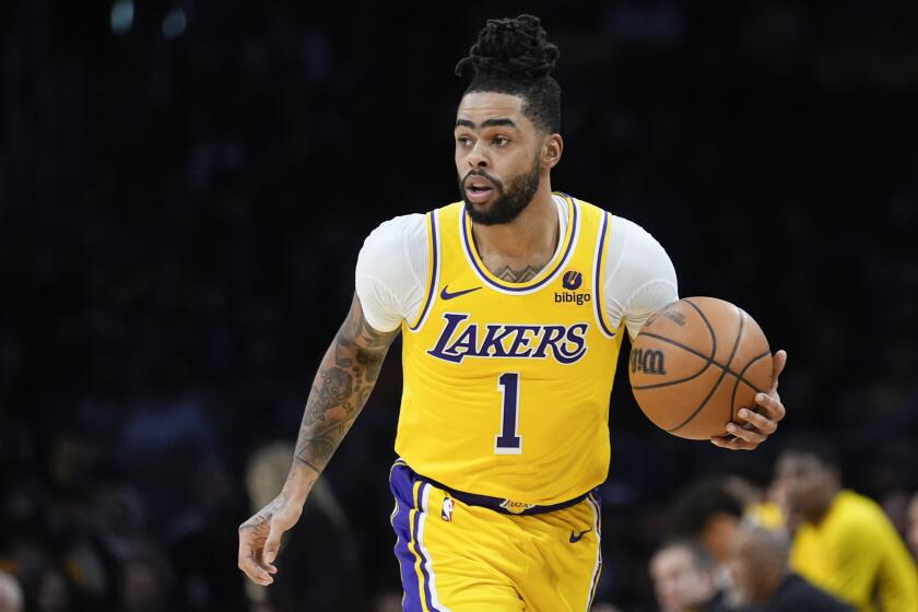 Los Angeles Lakers guard D'Angelo Russell (1) dribbles against the Dallas Mavericks, during the second half of an NBA basketball game Wednesday, Jan. 17, 2024, in Los Angeles. (AP Photo/Marcio Jose Sanchez)