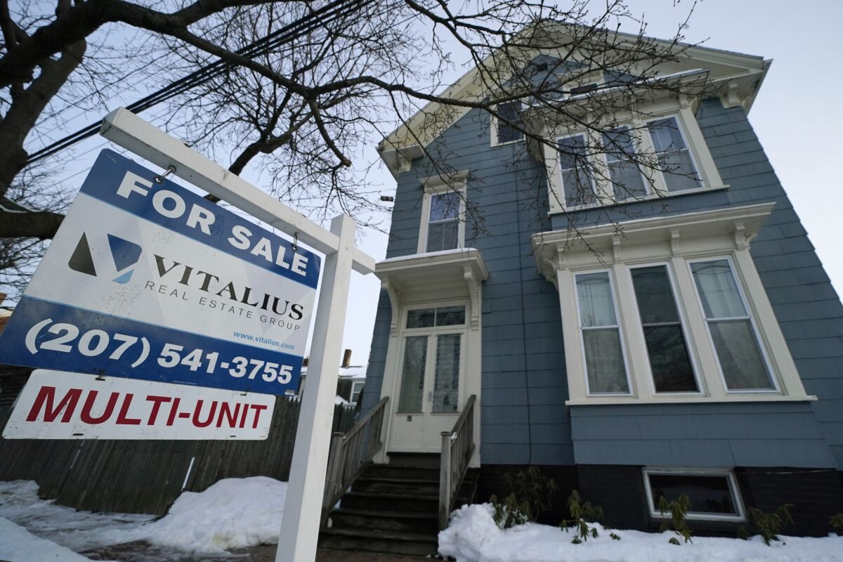 A sign announces a home for sale on Munjoy Hill, Wednesday, Jan. 25, 2023, in Portland, Maine. On Thursday, Freddie Mac reports on this week's average U.S. mortgage rates. (AP Photo/Robert F. Bukaty)