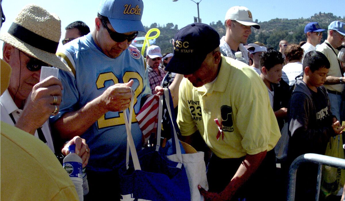 Security checks a UCLA fan's bag prior to a game.