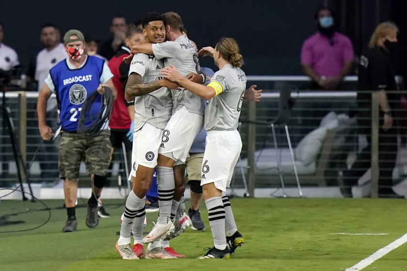 Montreal forward Bjorn Johnsen (9) celebrates with midfielder Djordje Mihailovic (8) and midfielder Samuel Piette (6) after scoring a goal during the first half of the team's MLS soccer match against Inter Miami, Wednesday, May 12, 2021, in Fort Lauderdale, Fla. (AP Photo/Lynne Sladky)