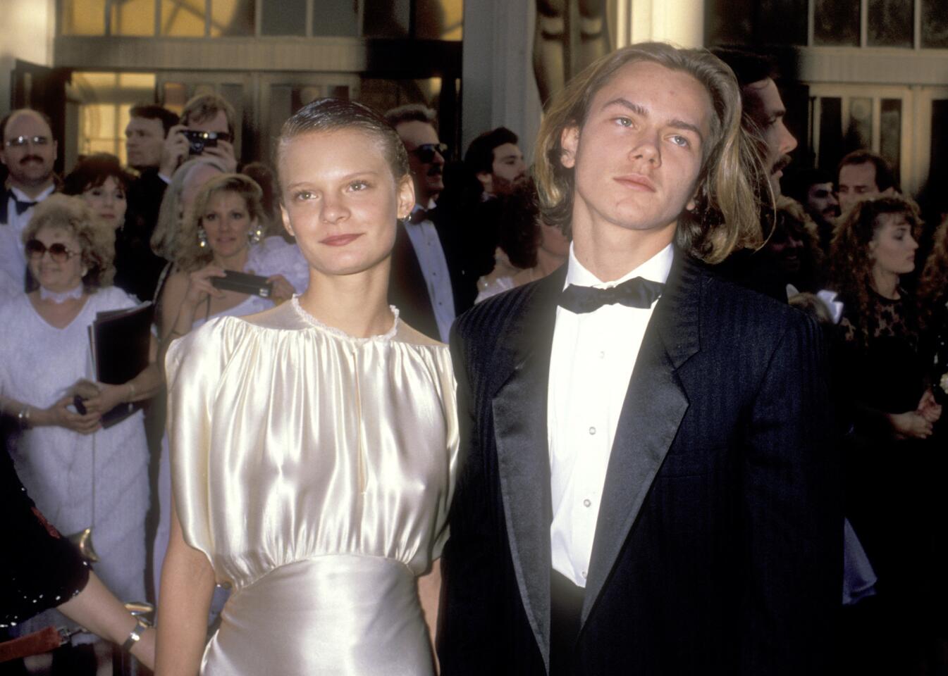 Martha Plimpton and River Phoenix at the 1989 Academy Awards at the Shrine Auditorium in Los Angeles. They appeared together in the 1986 film "The Mosquito Coast."