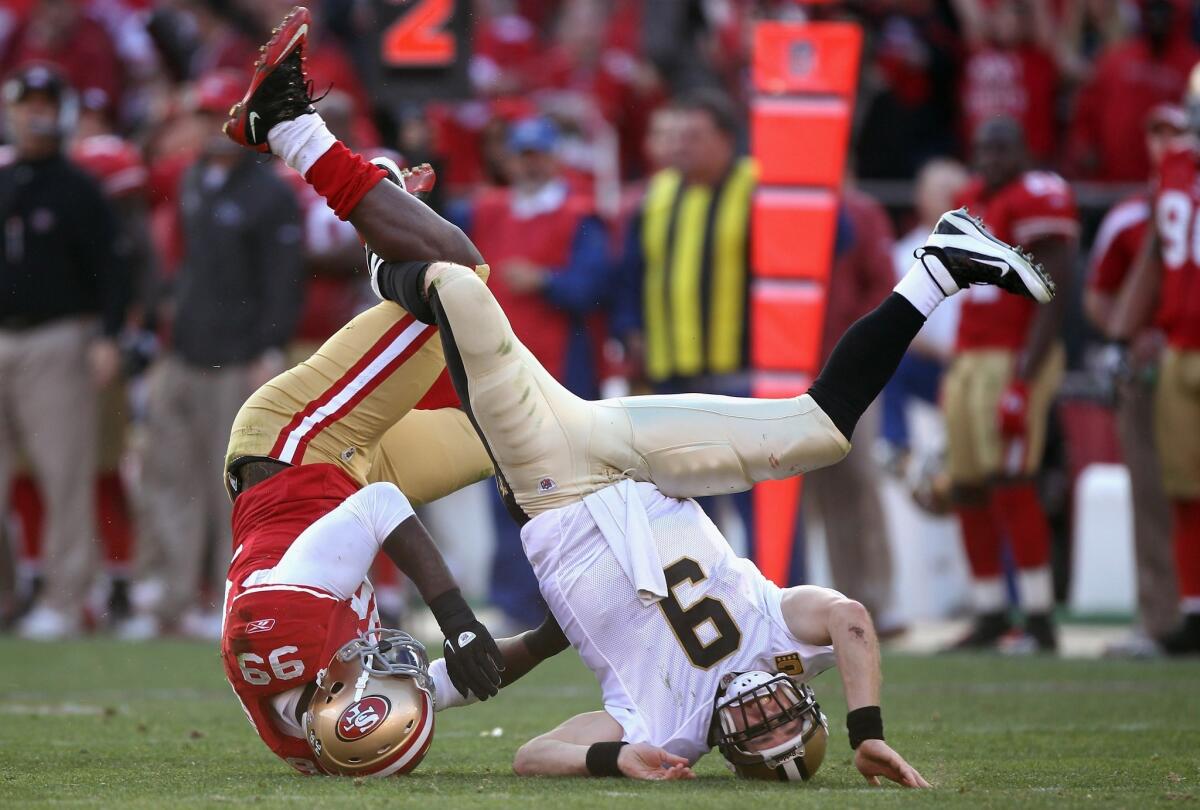 San Francisco linebacker Aldon Smith upends New Orleans quarterback Drew Brees during the NFC divisional round of the playoffs at Candlestick Park in 2012.