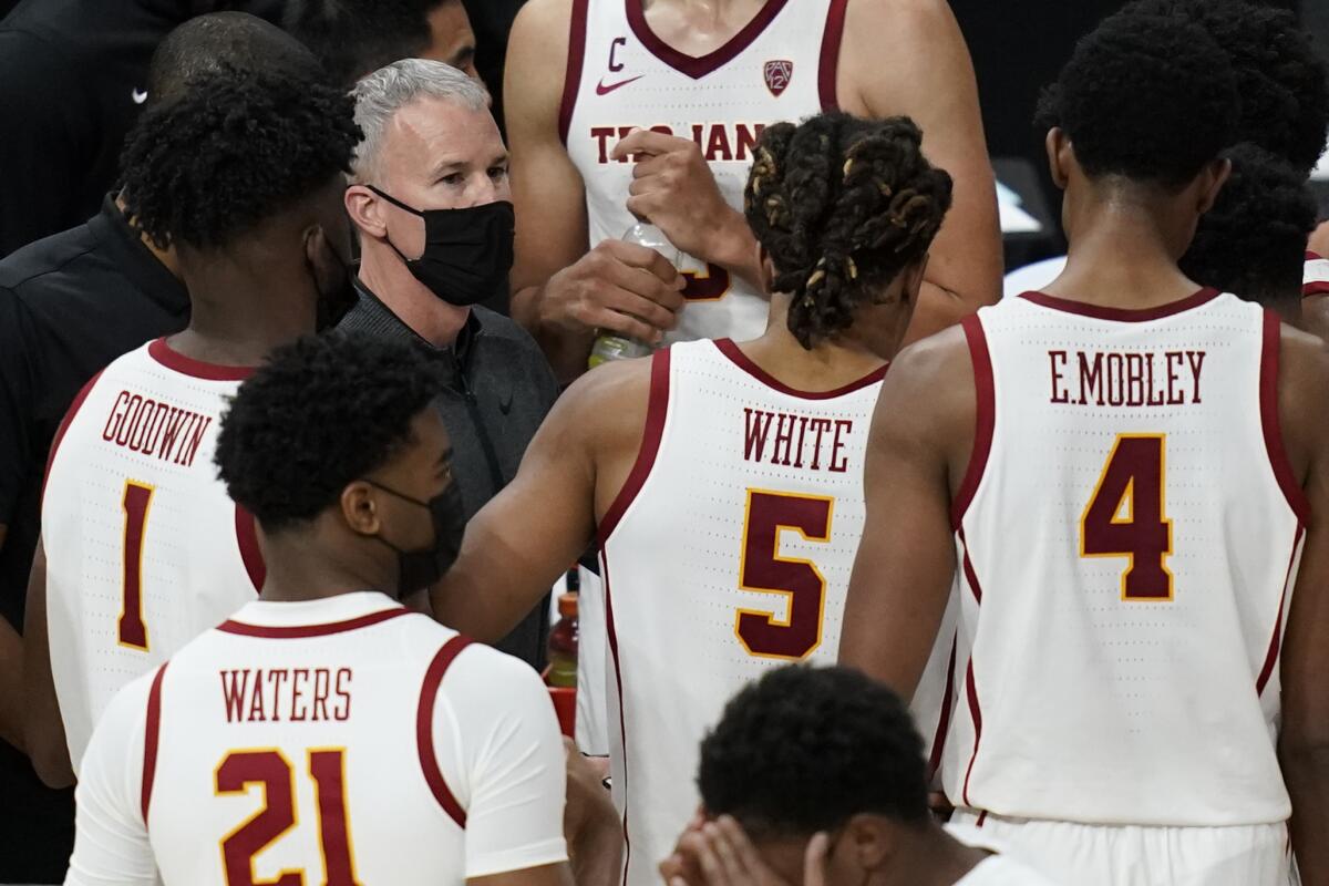 USC coach Andy Enfield speaks with his players at a timeout.