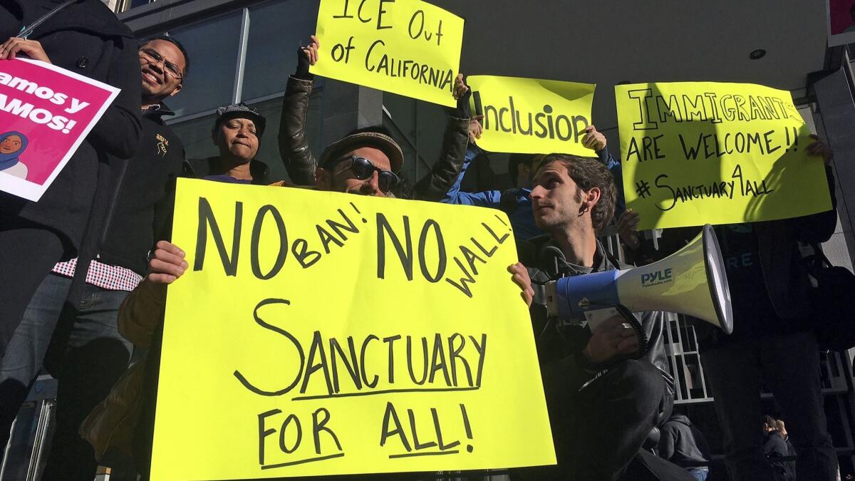 Protesters outside the federal courthouse in San Francisco in 2017, when a judge blocked the Trump administration from withholding funds from "sanctuary" cities. An appeals court on Wednesday ruled against the administration in the case.