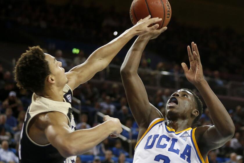 UCLA guard Aaron Holiday (3) attempts a shot while being guarded by Western Michigan guard Bryce Moore (0) in the second half at Pauly Pavillion.