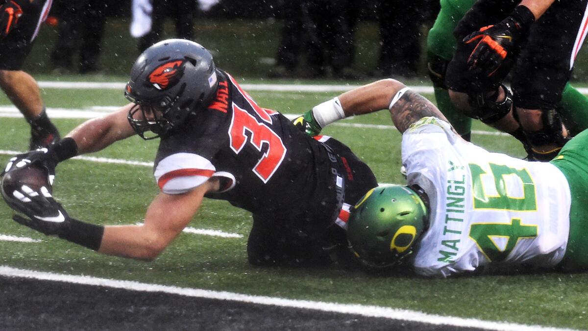 Oregon State running back Ryan Nall stretches for the goal line as he's tackled by Oregon linebacker Danny Mattingly during the fourth quarter Saturday.