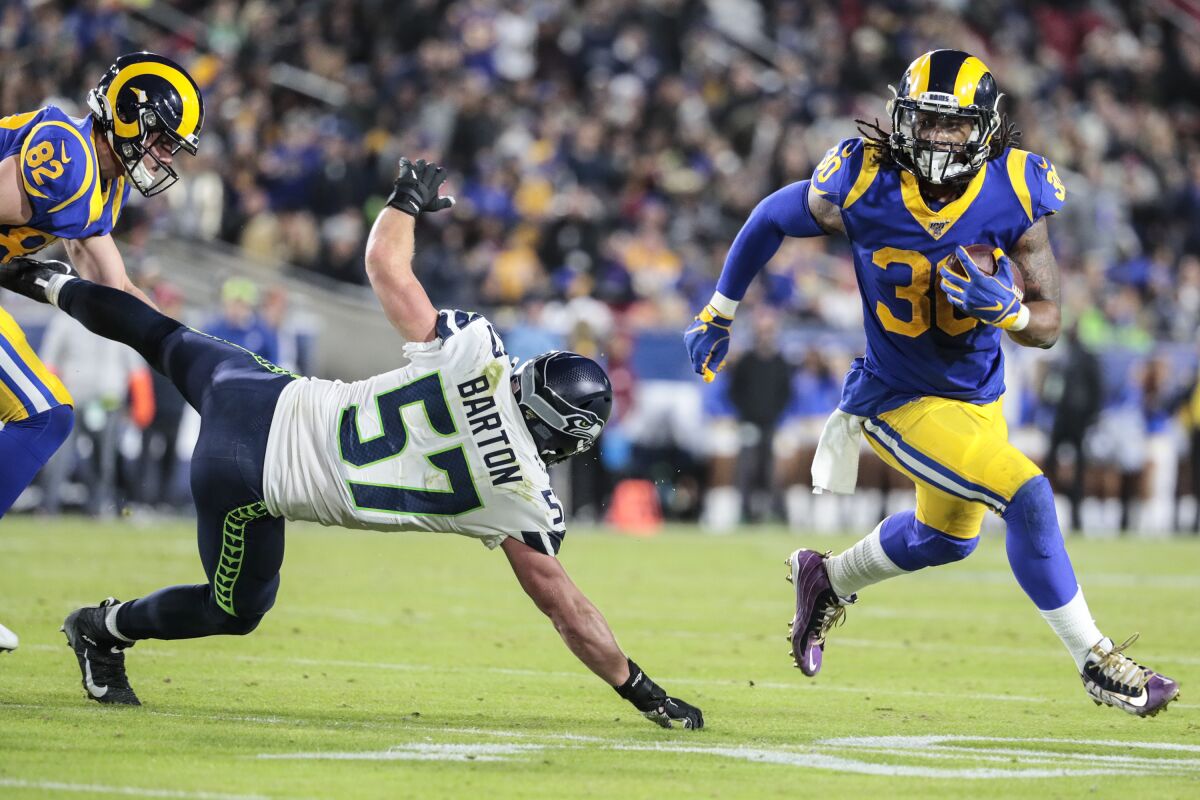 Rams running back Todd Gurley sprints past Seattle Seahawks linebacker Cody Barton.