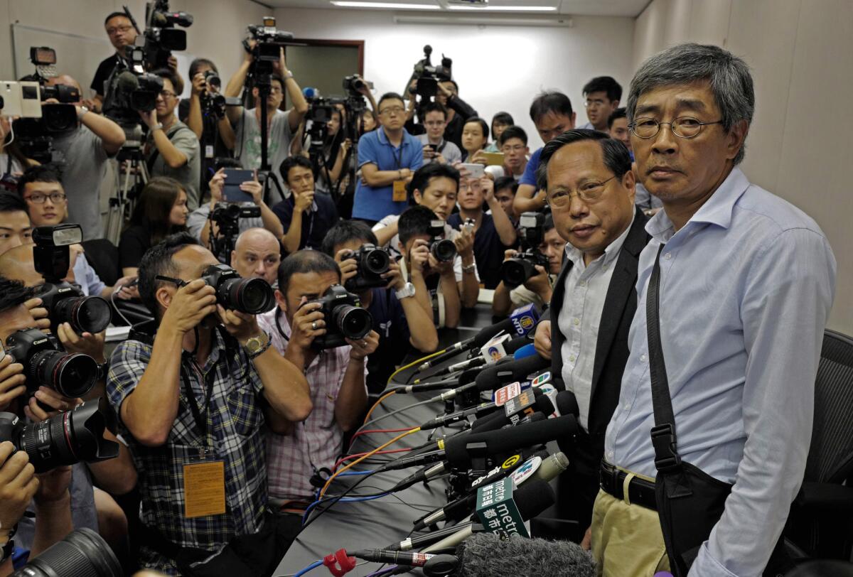 Freed bookseller Lam Wing Kee, right, is accompanied by pro-democracy lawyer Albert Ho, second from right, at a news conference in Hong Kong on June 16, 2016.