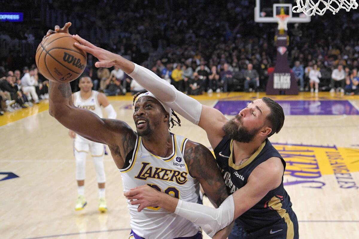 Lakers center Dwight Howard and New Orleans Pelicans center Jonas Valanciunas battle for a rebound.