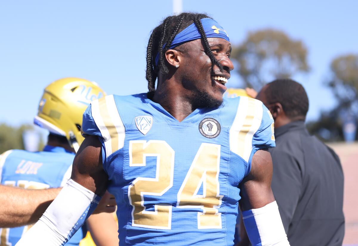 Starting UCLA cornerback Qwuantrezz Knight looks around during a practice