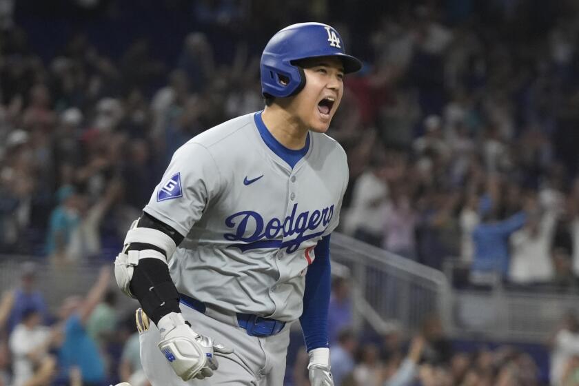 Los Angeles Dodgers' Shohei Ohtani (17) reacts after hitting his 50th home run of the season.