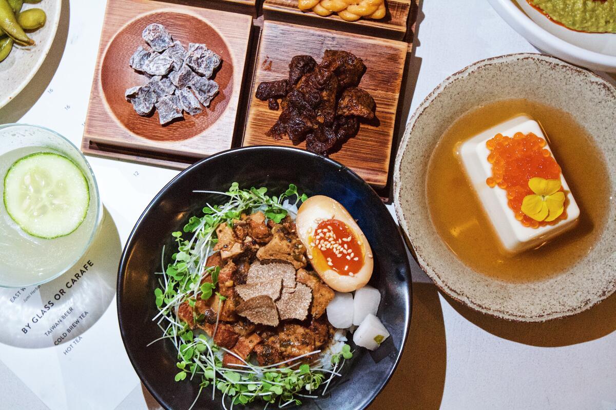 An assortment of dishes including truffle-braised pork rice and an umami-themed snack board.