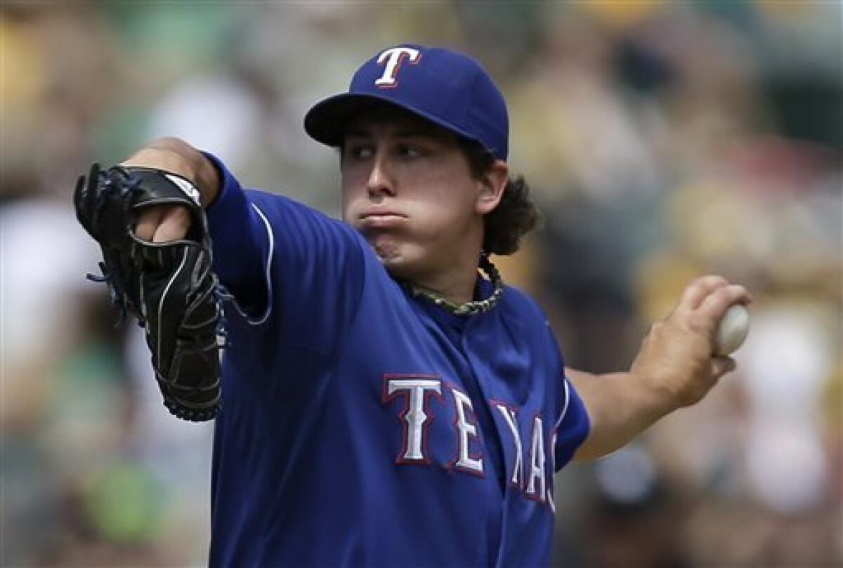 Texas Rangers starting pitcher Derek Holland works against the