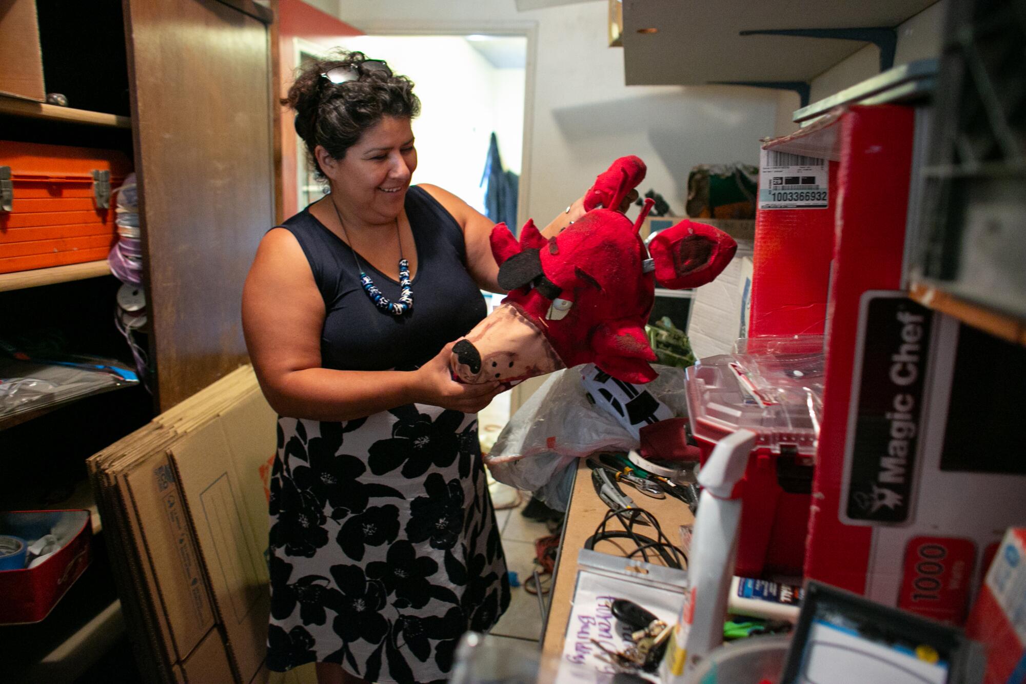 Luz Puebla holds up a Halloween costume