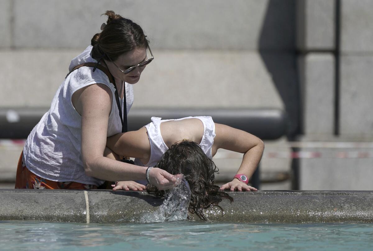 Person wetting her hair in a fountain