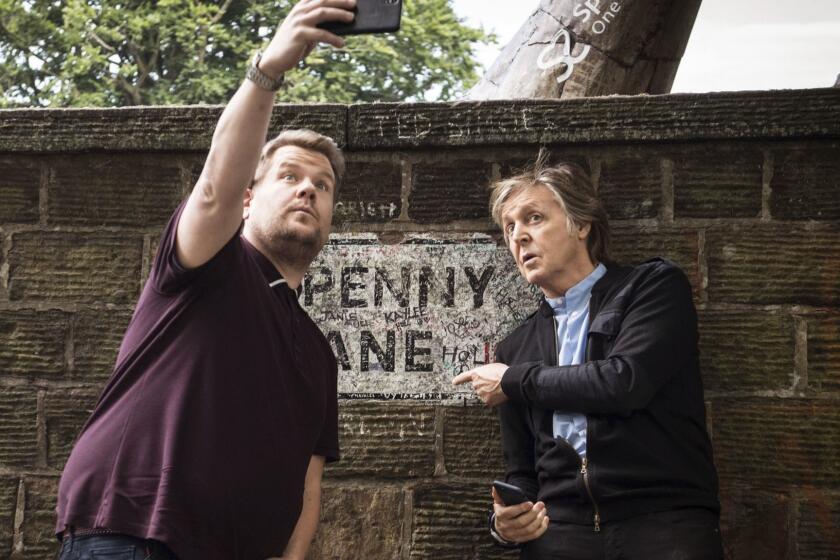 In this image released by CBS, Paul McCartney, right, joins host James Corden as they take a selfie on Penny Lane during the "Carpool Karaoke" segment on "The Late Late Show with James Corden." (Craig Sugden/CBS via AP)