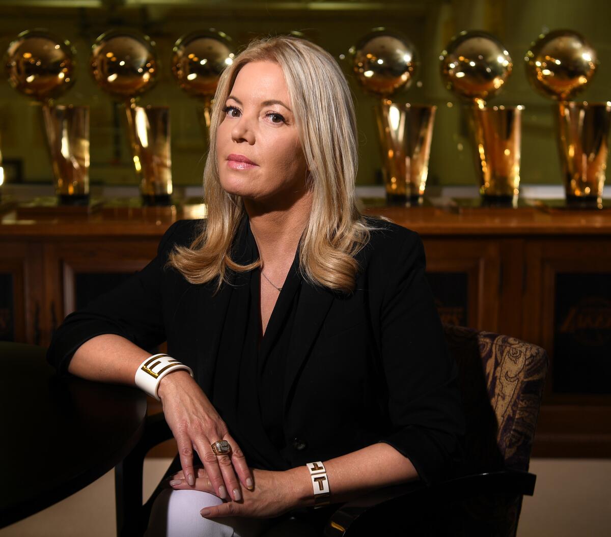 Jeannie Buss, President of the Los Angeles Lakers, sits next to champioship trophies at her office in El Segundo.