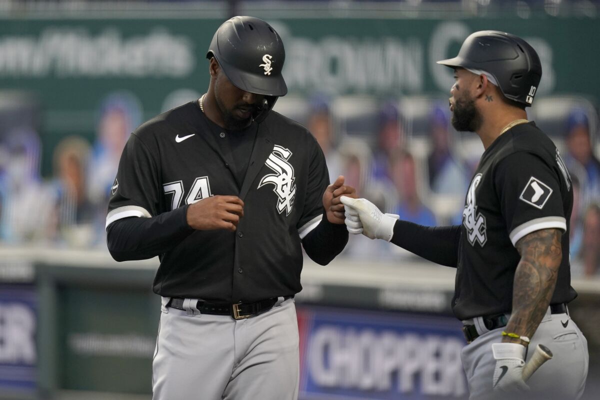 Chicago White Sox's Eloy Jimenez (74) is congratulated by Tim Anderson after scoring a run during the first inning of the team's baseball game against the Kansas City Royals at Kauffman Stadium in Kansas City, Mo., Friday, Sept. 4, 2020. (AP Photo/Orlin Wagner)
