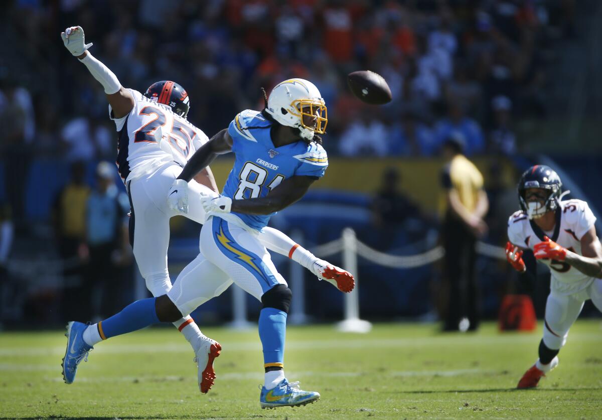 Chris Harris (25), now a member of the Chargers, breaks up a pass intended for L.A. receiver Mike Williams when the cornerback was a member of the Denver Broncos.