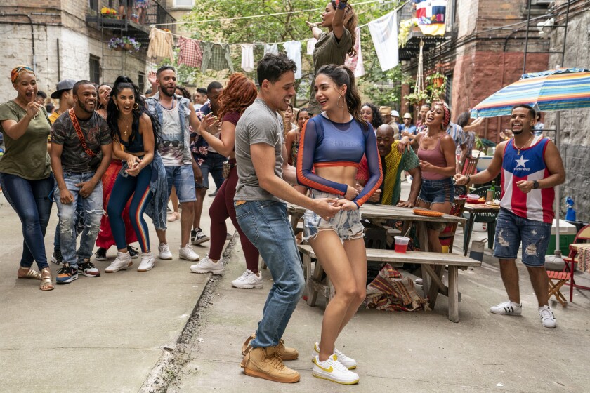 This image released by Warner Bros. Picures shows Anthony Ramos, foreground left, and Melissa Barrera in a scene from "In the Heights." (Macall Polay/Warner Bros. Entertainment via AP)