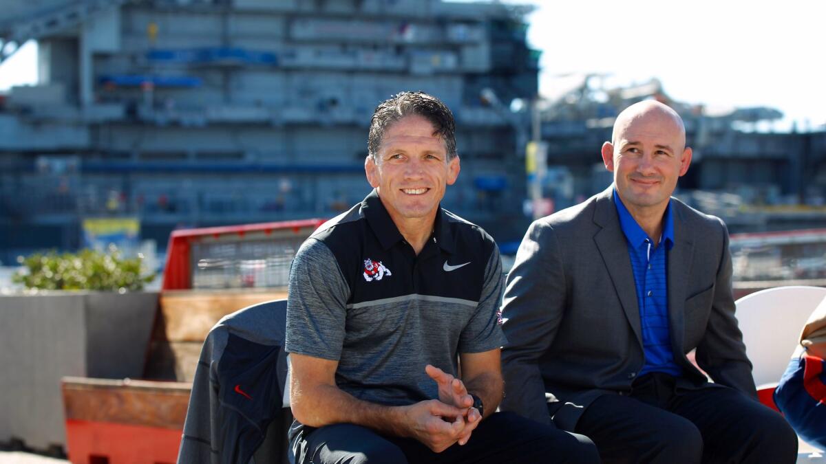 Fresno State wrestling coach Troy Steiner, left, joined Air Force coach Sam Barber at a Nov. 9 news conference for the "Battle on The Midway" dual meet scheduled for Tuesday.