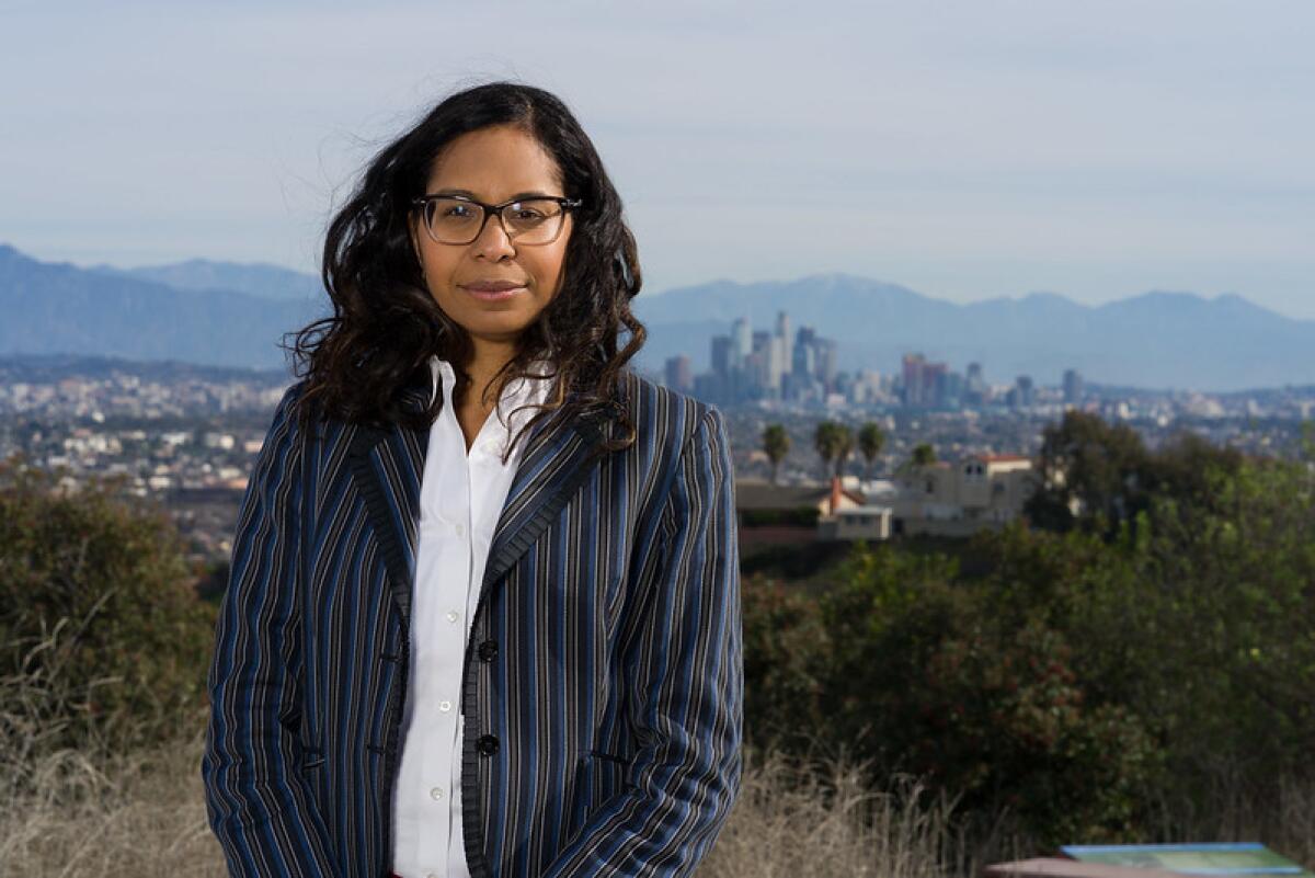 Assemblywoman Sydney Kamlager (D-Los Angeles) poses for a photograph with the city skyline and mountains in the background.