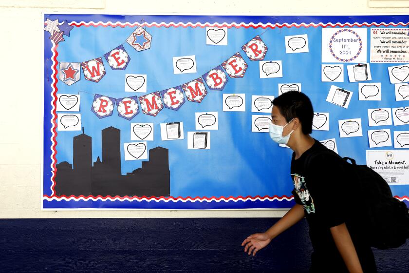 ARCADIA-CA-SEPTEMER 10, 2021: Middle school students place messages on a board commemorating 9/11 at First Avenue Middle School in Arcadia on Friday, September 10, 2021. (Christina House / Los Angeles Times)
