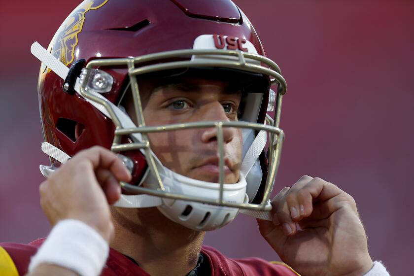 LOS ANGELES, CALIF. - SEP. 7, 2019. USC quarterback Kedon Slovis straps on his helmet before taking the field for the game against Stanford at the L.A. Memorial Coliseum on Saturday night, Sep. 7, 2019. (Luis Sinco/Los Angeles Times)