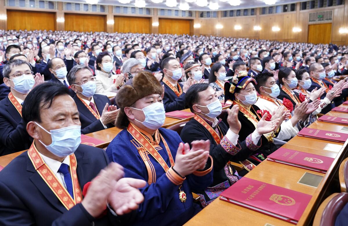 Attendees applaud at a ceremony in Beijing