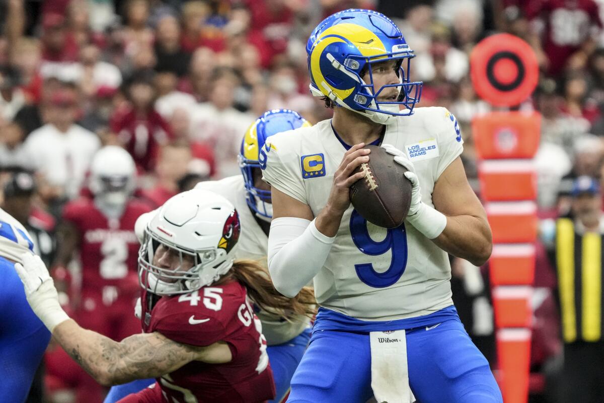 Rams quarterback Matthew Stafford looks to pass during the first half Sunday.